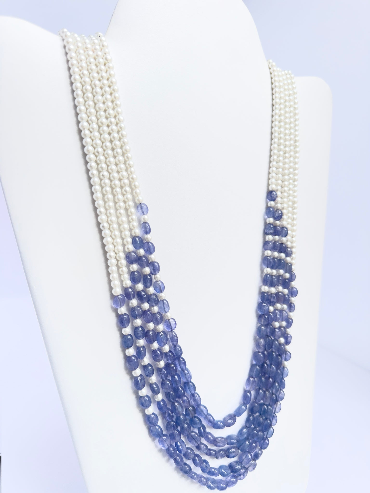 Elegant 5-strand necklace combining quartz and pearls, smooth oval design, 49–59cm adjustable length.