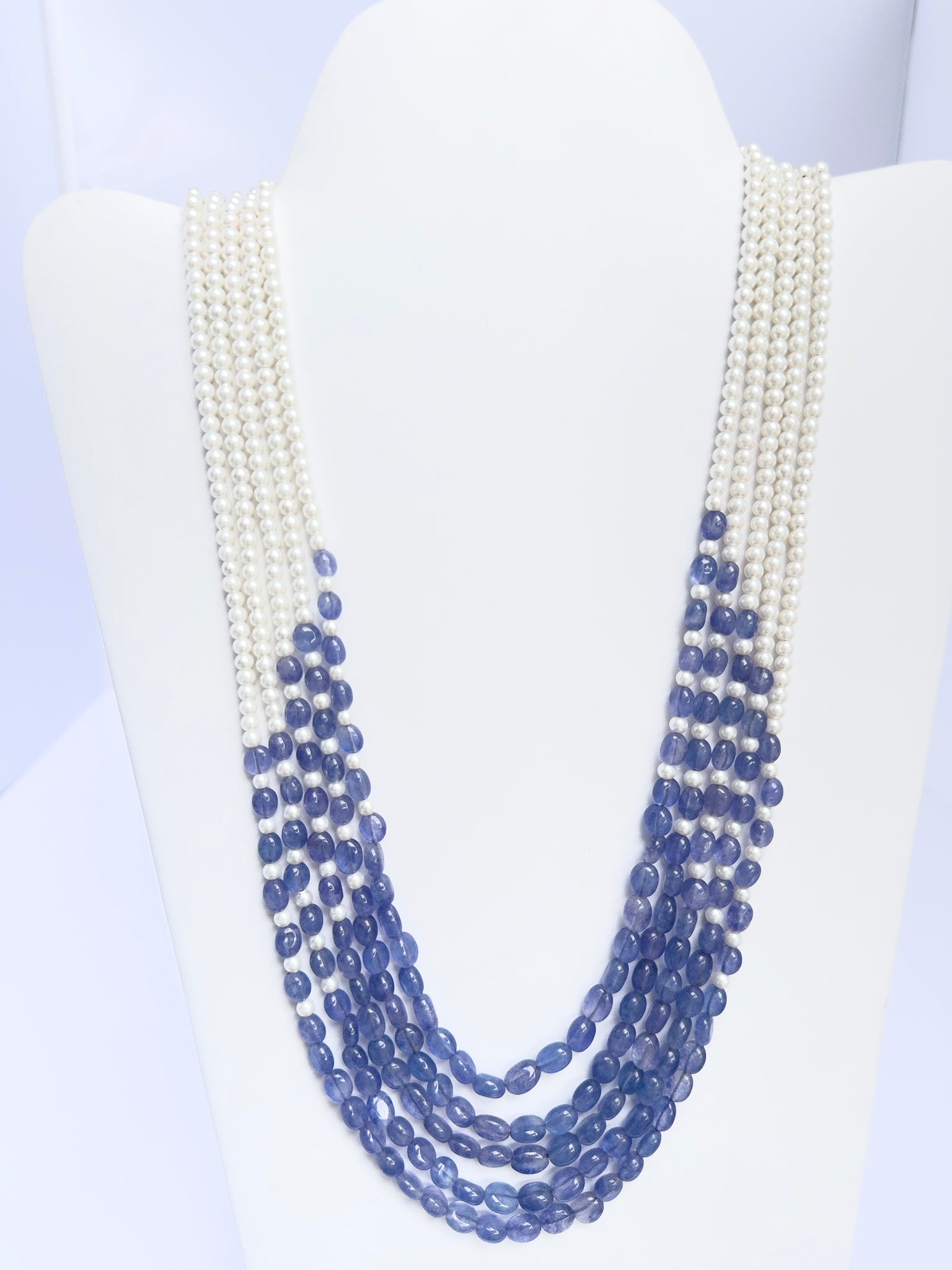 Necklace showcasing natural quartz and shell pearls, smooth oval cut, versatile styling.