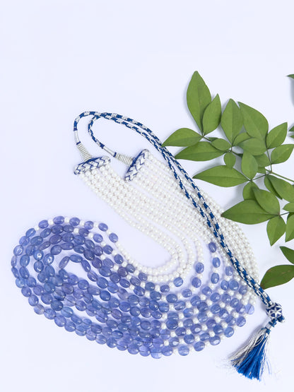 Artisan-crafted necklace featuring quartz and pearls, radiant finish, adjustable silk tassel.