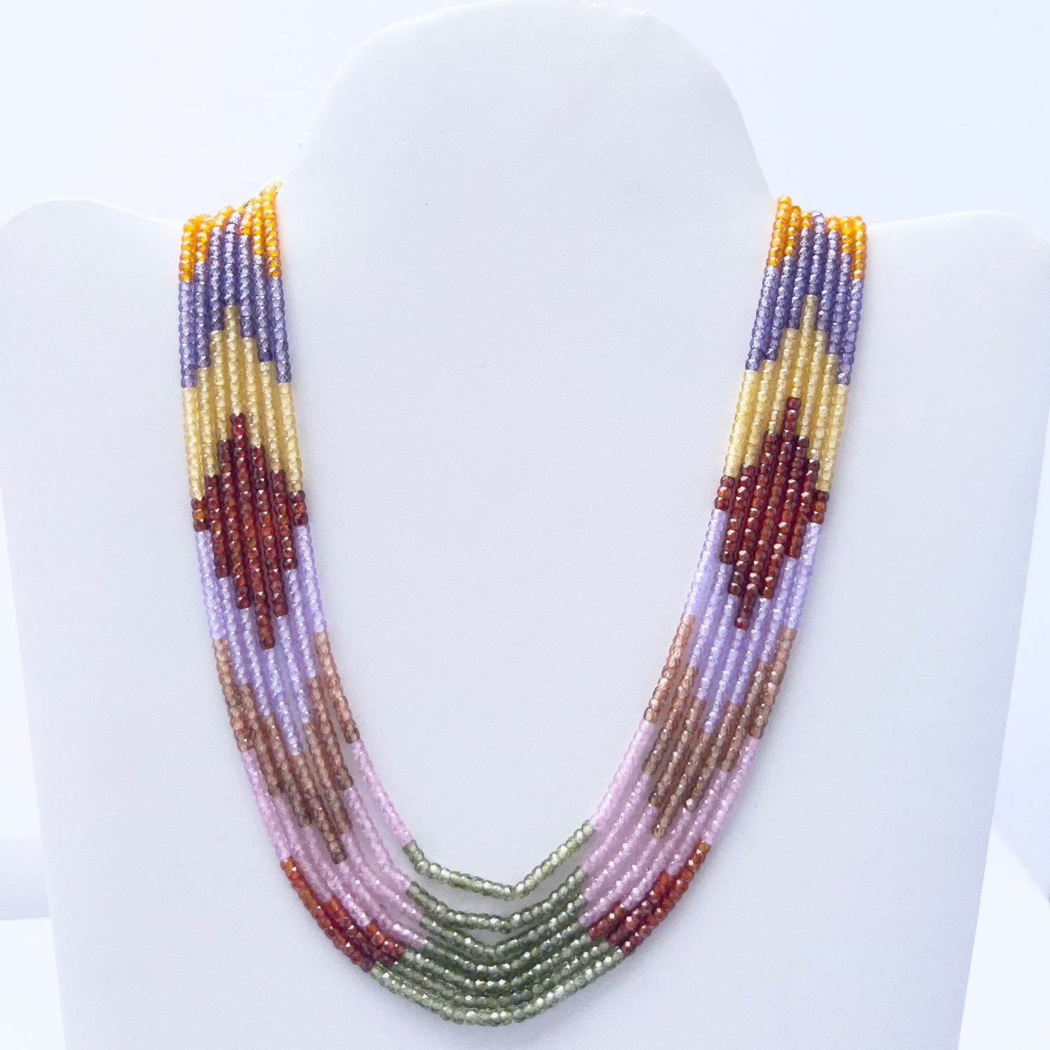 Close-up of Cubic Zirconia gemstone beads, faceted rondelle cut, shimmering brilliance, arranged in strands.