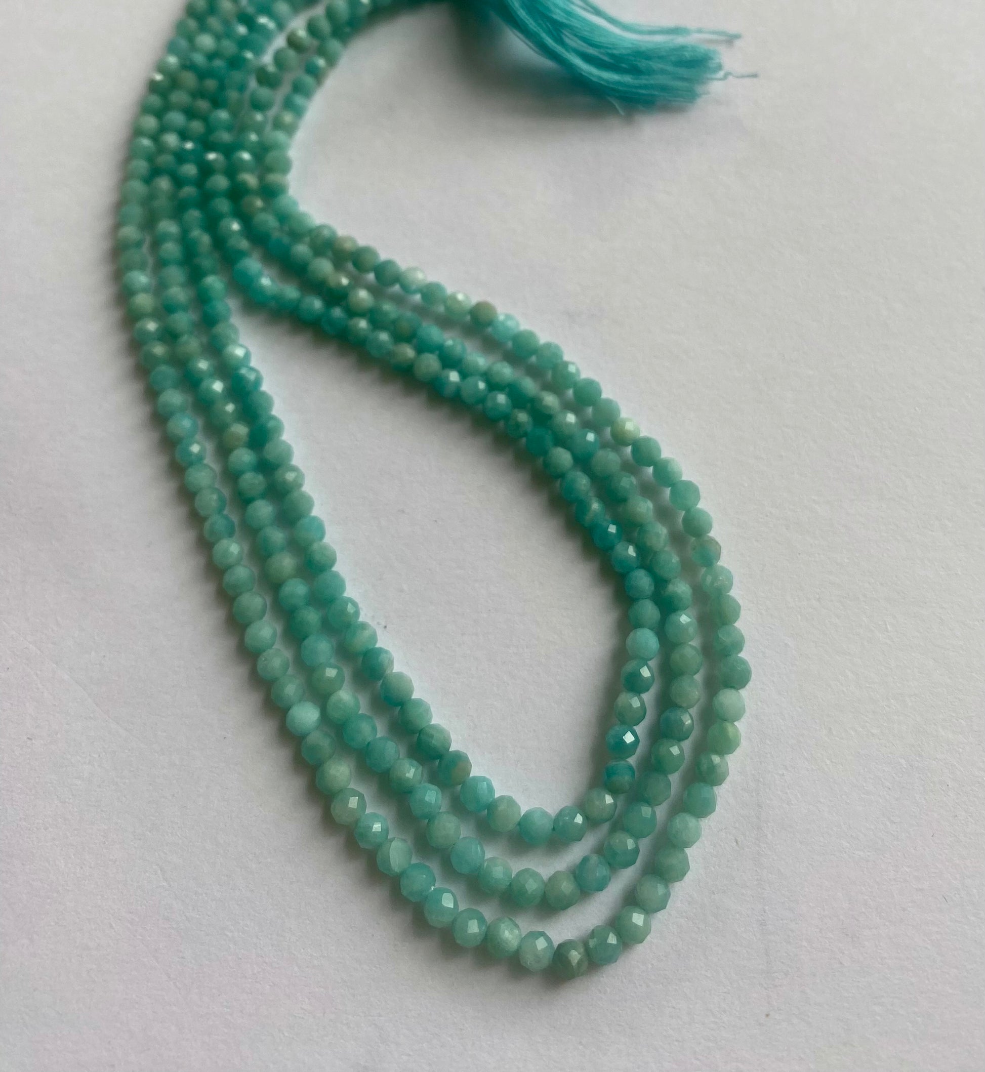  Strands of green Amazonite beads, faceted rondelle style, measuring 3.4-3.5mm, with a total length of 31cm.