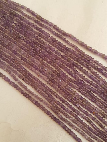 Elegant strands adorned with 2.5mm faceted rondelle amethyst stones, in bulk, showcasing a rich purple colour.