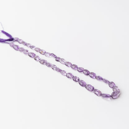 Genuine Amethyst gemstone beads arranged on a 32cm strand with vibrant violet tones and premium quality.