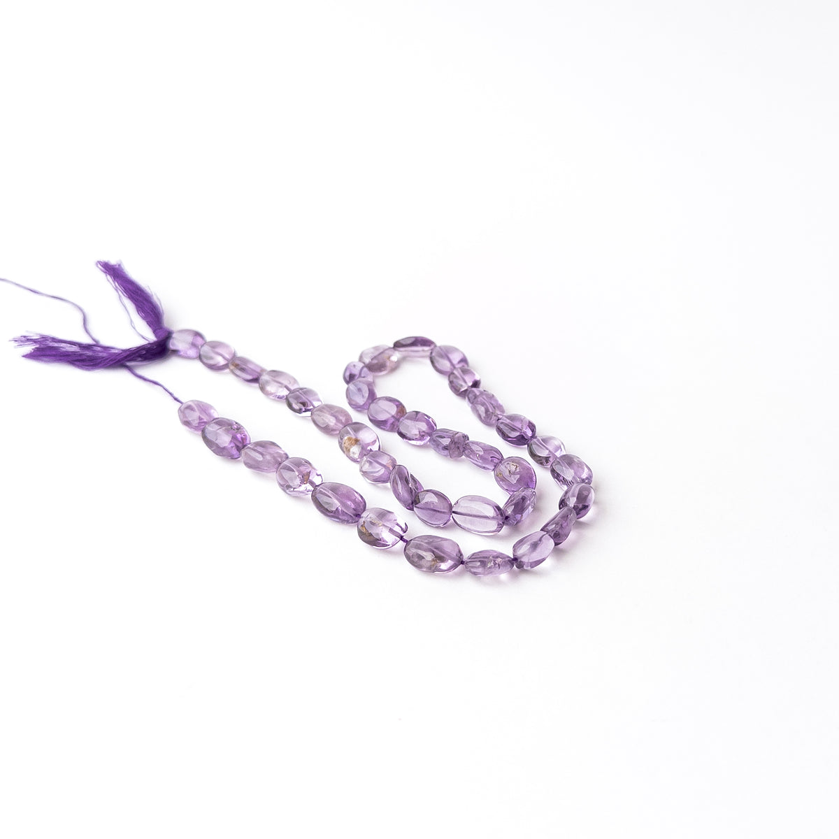 Authentic Amethyst stone beads featuring smooth oval cuts that highlight the gemstone's natural beauty and colour.