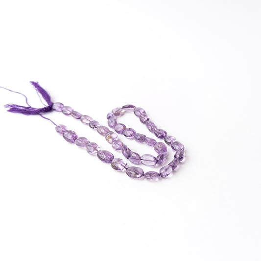 Authentic Amethyst stone beads featuring smooth oval cuts that highlight the gemstone's natural beauty and colour.