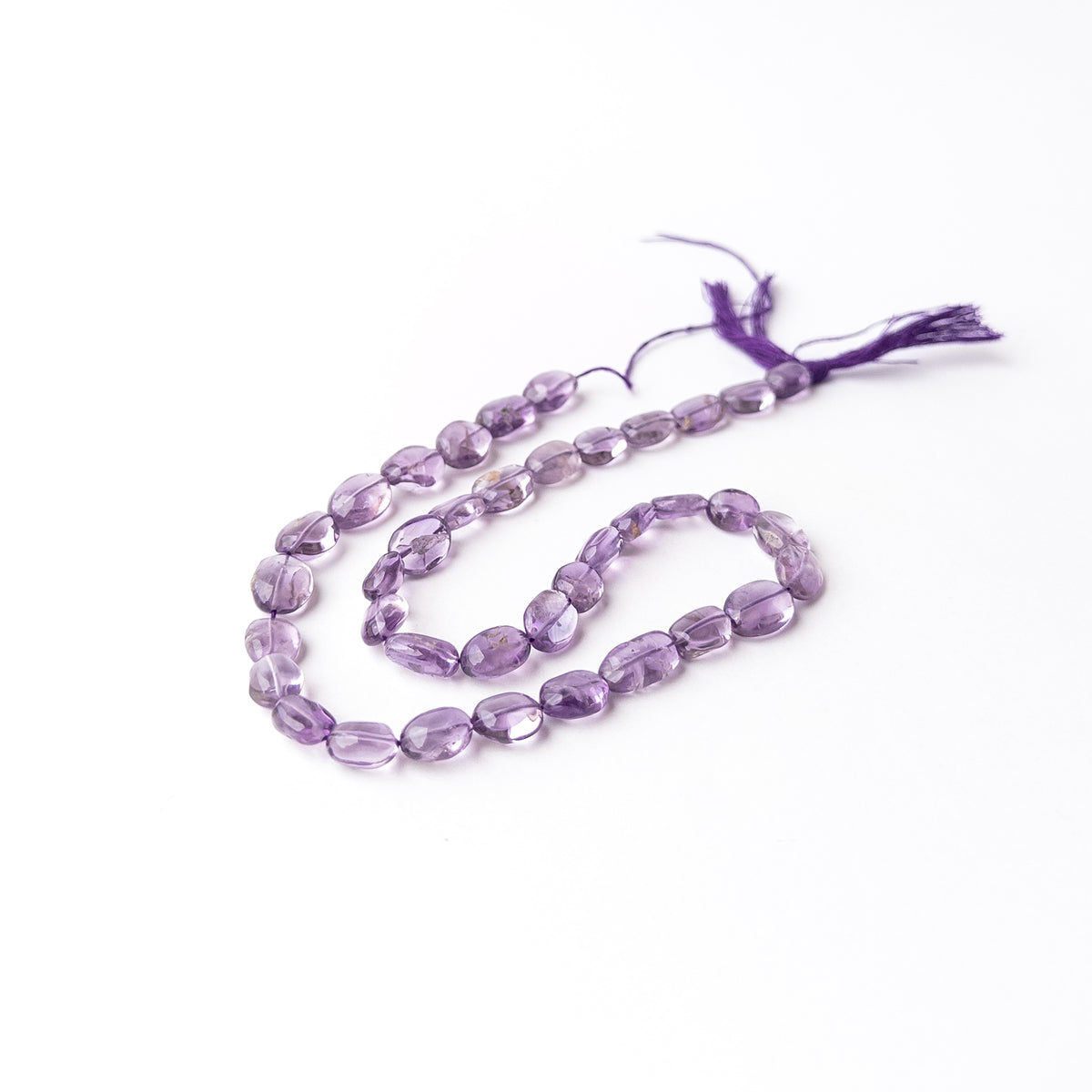 Amethyst smooth oval gemstone beads displaying rich purple hues with a polished finish and elegant rounded shape.