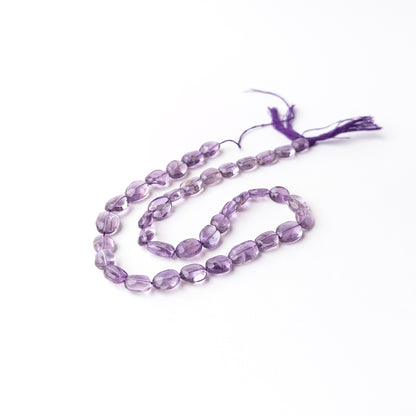 Amethyst smooth oval gemstone beads displaying rich purple hues with a polished finish and elegant rounded shape.
