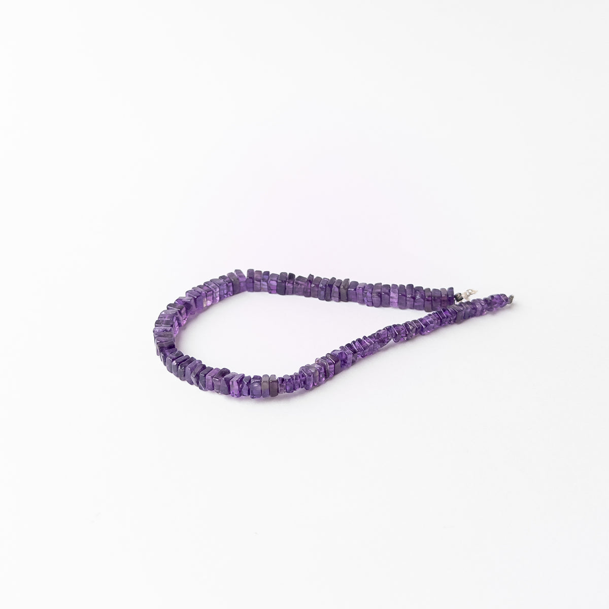 Handmade jewellery components showcasing smooth Amethyst beads with attractive square heishi styling and lustre.