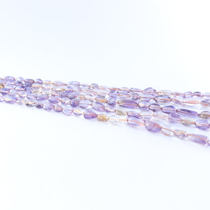 Ametine smooth tumble gemstone beads in blended purple‑gold tones arranged on a 32cm strand for handmade jewellery components.