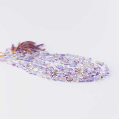 High‑quality Ametine smooth tumble beads in 6–6.5mm size offering clarity and shine for artisan jewellery projects.
