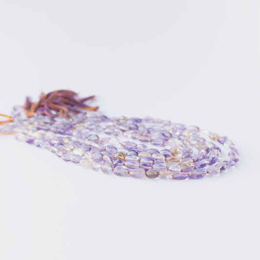 High‑quality Ametine smooth tumble beads in 6–6.5mm size offering clarity and shine for artisan jewellery projects.