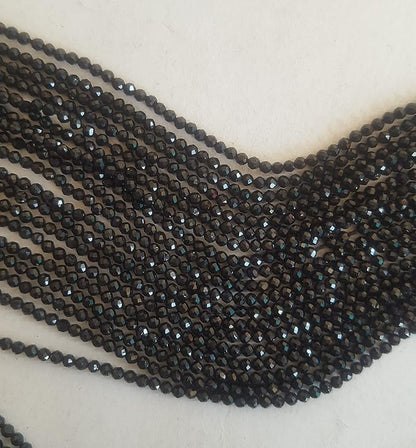 Elegant strands adorned with 2mm black spinel faceted rondelle beads, showcasing a sleek design.