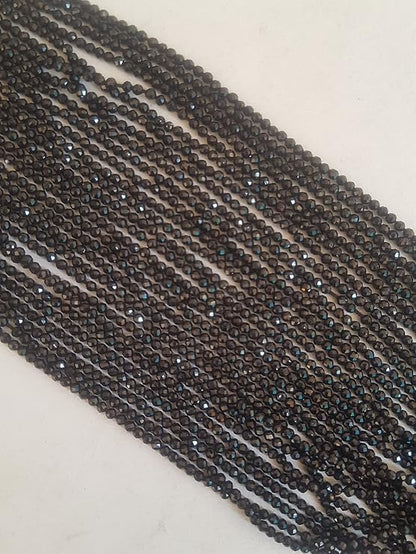 A close-up of a multiple strands  featuring black spinel faceted rondelle beads, measuring 2mm in size.