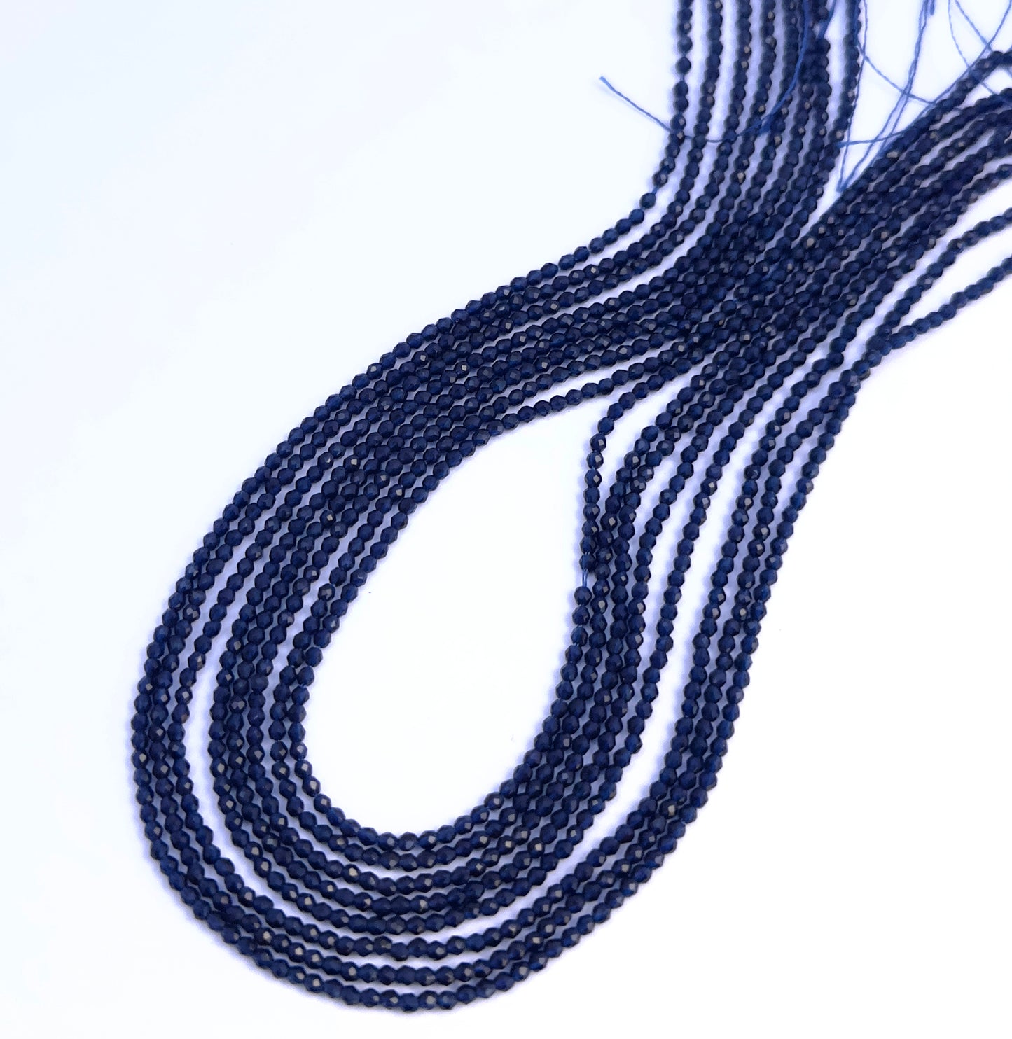 Close-up of Blue-Quartz gemstone beads showing faceted cut and sparkling finish.