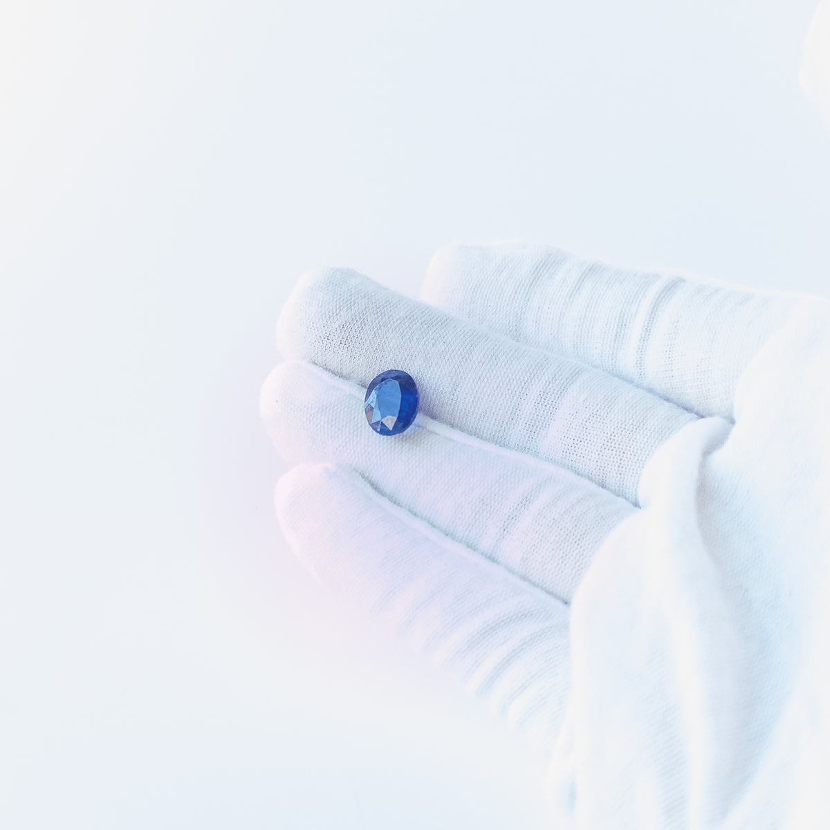 Blue Sapphire faceted oval cabochon with deep blue colour and polished shine, ideal for fine jewellery making.