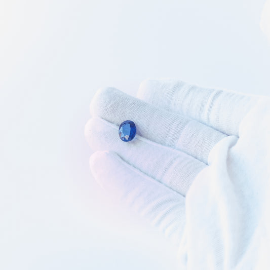 Blue Sapphire faceted oval cabochon with deep blue colour and polished shine, ideal for fine jewellery making.