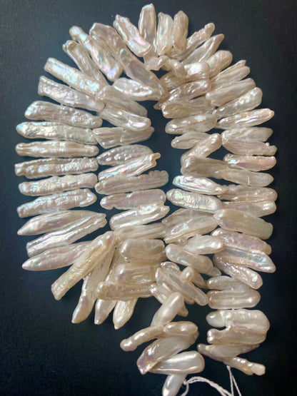 Macro image of Baroque pearls highlighting their natural contours and soft iridescence.