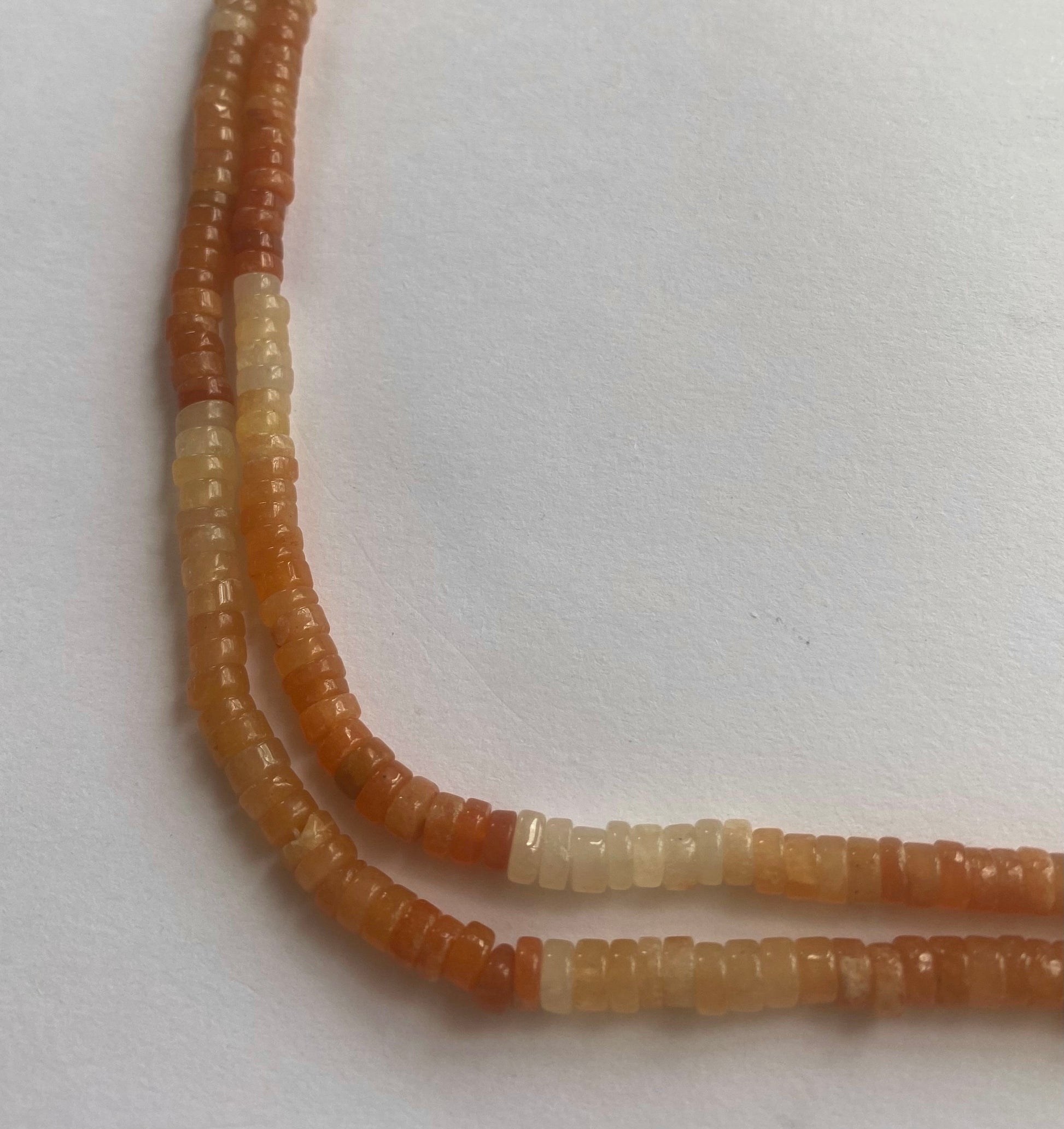 Strands of polished carnelian beads, 5.5mm, displaying a bright and eye-catching colour.  