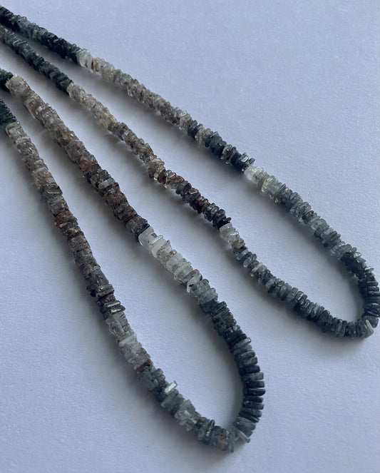 Smooth square heishi Change Garnet beads arranged in uniform rows on a 40cm strand.