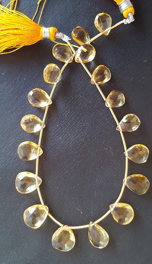  A striking strand with yellow beads resting on a black surface, showcasing the vivid colours and elegant design.