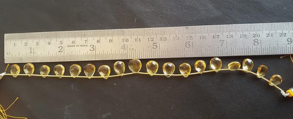 A ruler beside a faceted citrine natural gemstone bead.