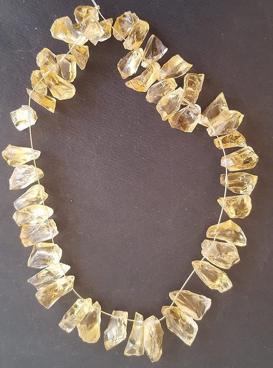 Elegant strand of rough yellow natural citrine gemstone, beads sized 7mm to 9mm, highlighting their natural beauty and vibrant colour.