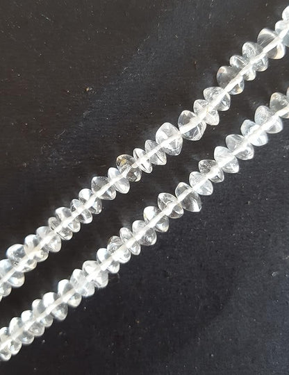  A crystal bead on a dark background, featuring capturing light beautifully.