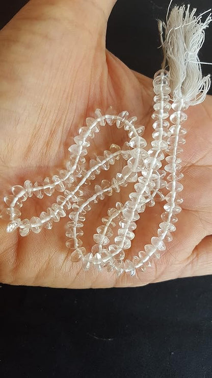 A person holding a strand crystal smooth beads, showcasing the colour and button shape.