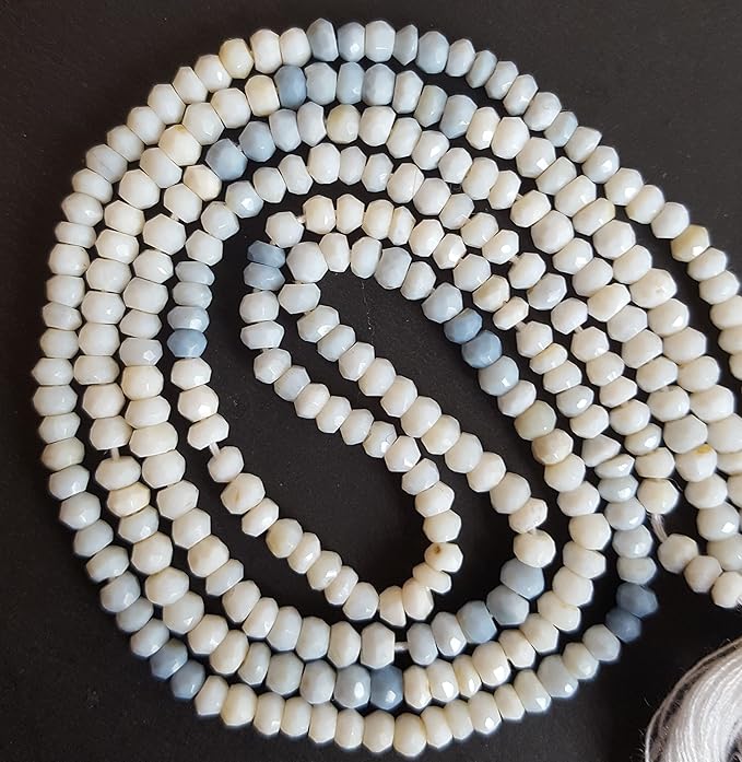 A long strand of 3.5mm denim opal beads, showcasing faceted rondelles, ideal for crafting and design.