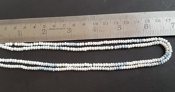 A denim opal stand made of faceted, rondelle beads, with a ruler beside it for size reference. 