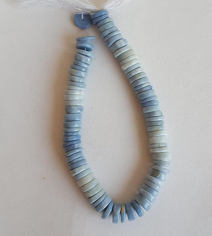 A strand displaying a variety of colourful stones, crafted from smooth wheel-shaped Denim Opal gemstone beads.