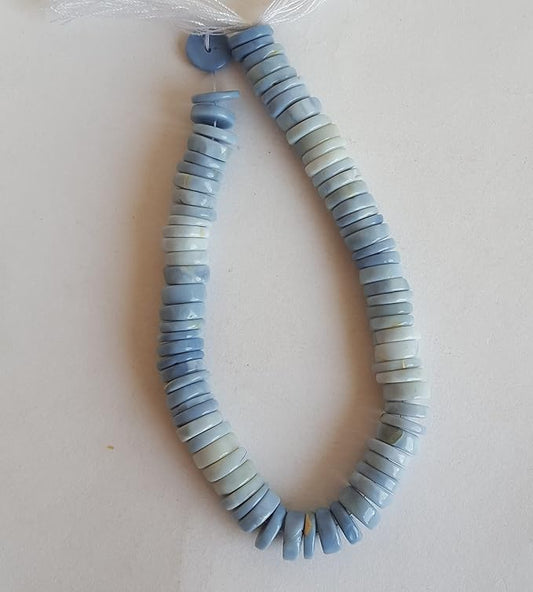 A strand displaying a variety of colourful stones, crafted from smooth wheel-shaped Denim Opal gemstone beads.