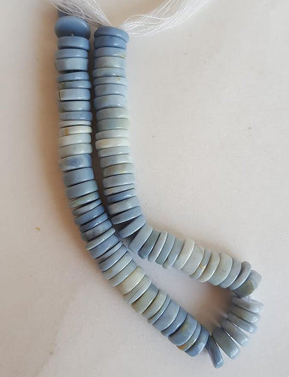 A vibrant strand featuring an array of colourful Denim Opal gemstone beads in smooth wheel shapes.