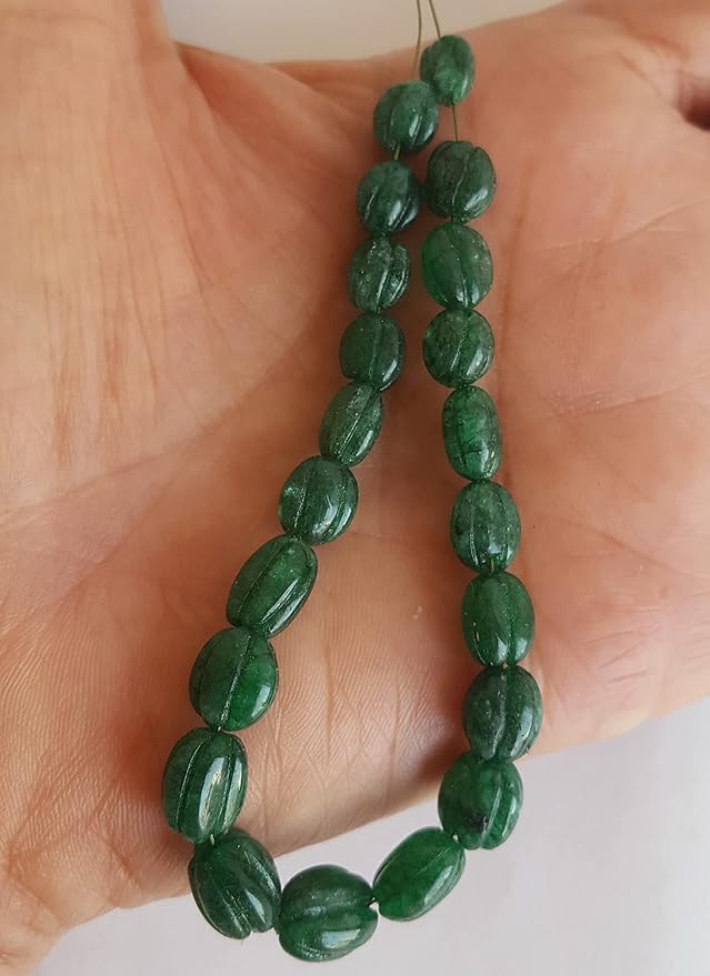  A close-up of a strand of green Emerald beads, highlighting their design and rich hue.