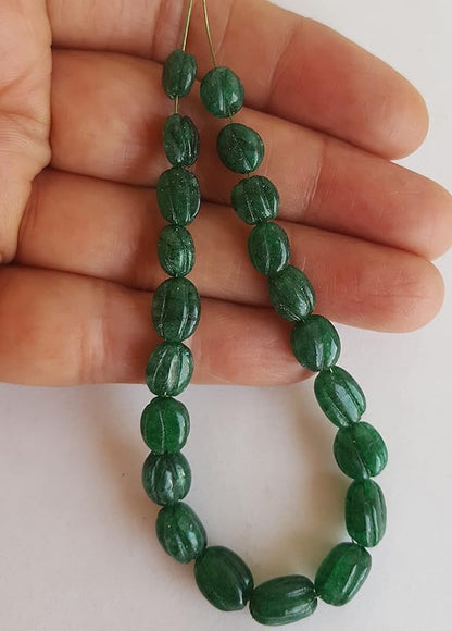 A strand of green amazonite beads,  carved oval shapes, showcasing their vibrant colour and shine.