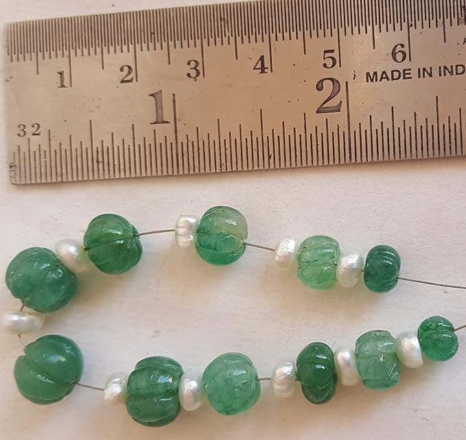 Green emerald bead with pearls displayed on a ruler, showcasing the size of the Emerald Fresh Water Pearls, 7mm to 10mm.