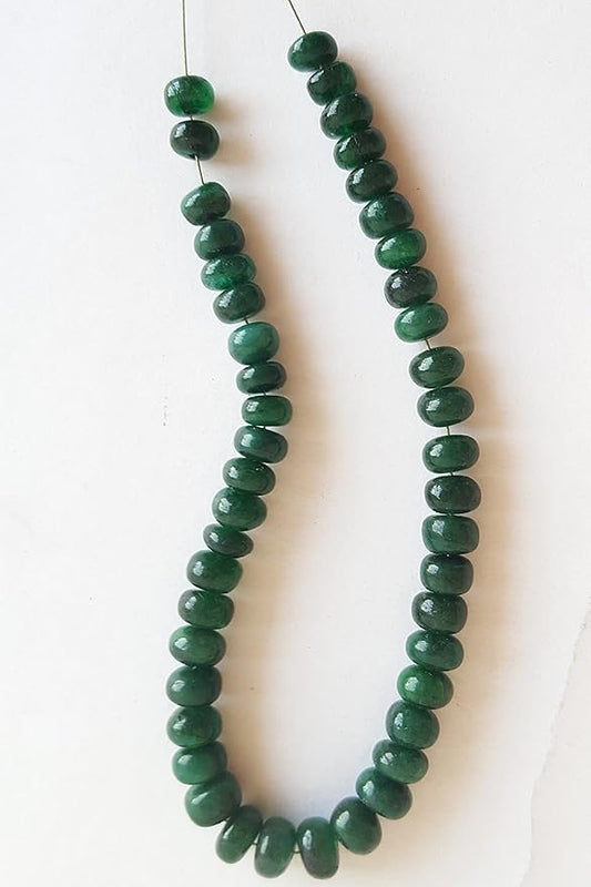 A strand of smooth emerald rondelle gemstone beads, measuring 5mm to 6mm, showcasing their vibrant colour and shine.