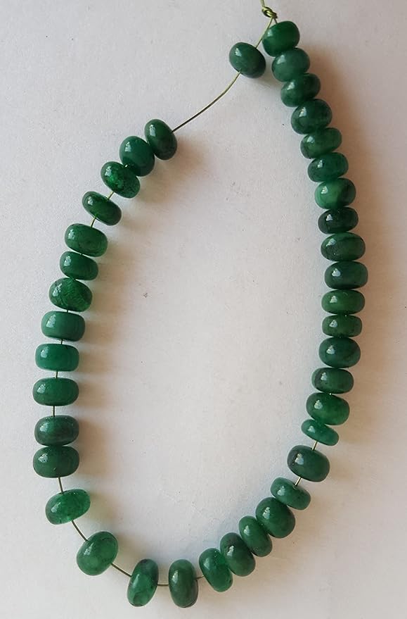 Elegant strand adorned with 5-6mm smooth emerald rondelle beads, highlighting their rich green hue.