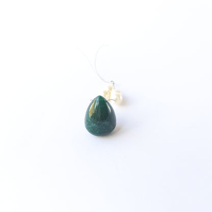 Genuine Emerald stone bead showcasing its smooth teardrop shape and vibrant green tone.