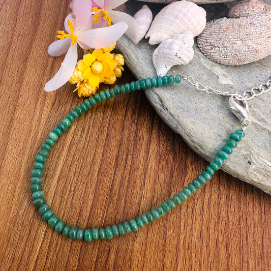 Smooth rondelle Emerald beads in 4–4.5mm size strung on an 18.5cm adjustable bracelet. 
