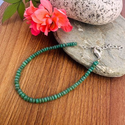 Close-up of gemstone beads featuring Emerald in soft green tones and polished cut. 