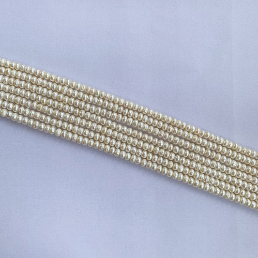 Freshwater Pearl rondelle beads glow with a creamy-white sheen, arranged beautifully along a 40cm strand.