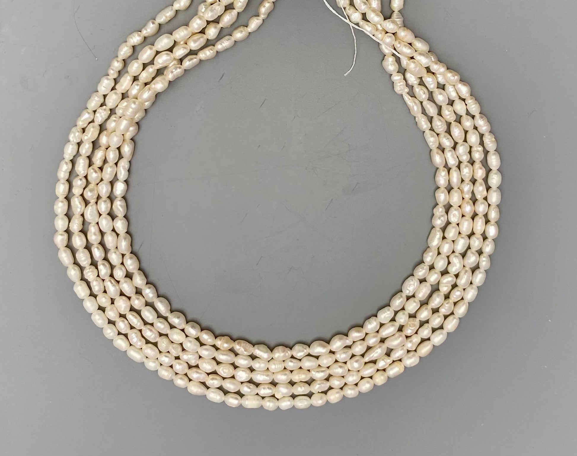 Lustrous freshwater baroque rice pearls, 3.4mm to 3.8mm, delicately strung on a 34cm strand.