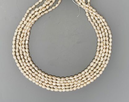 Lustrous freshwater baroque rice pearls, 3.4mm to 3.8mm, delicately strung on a 34cm strand.