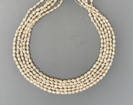 Lustrous freshwater baroque rice pearls, 3.4mm to 3.8mm, delicately strung on a 34cm strand.