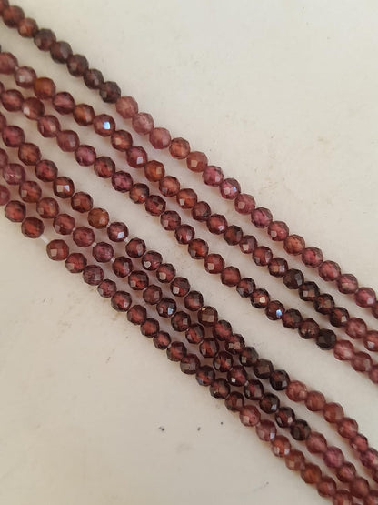 A gemstone bead strand showcasing Garnet faceted rondelle gemstones.