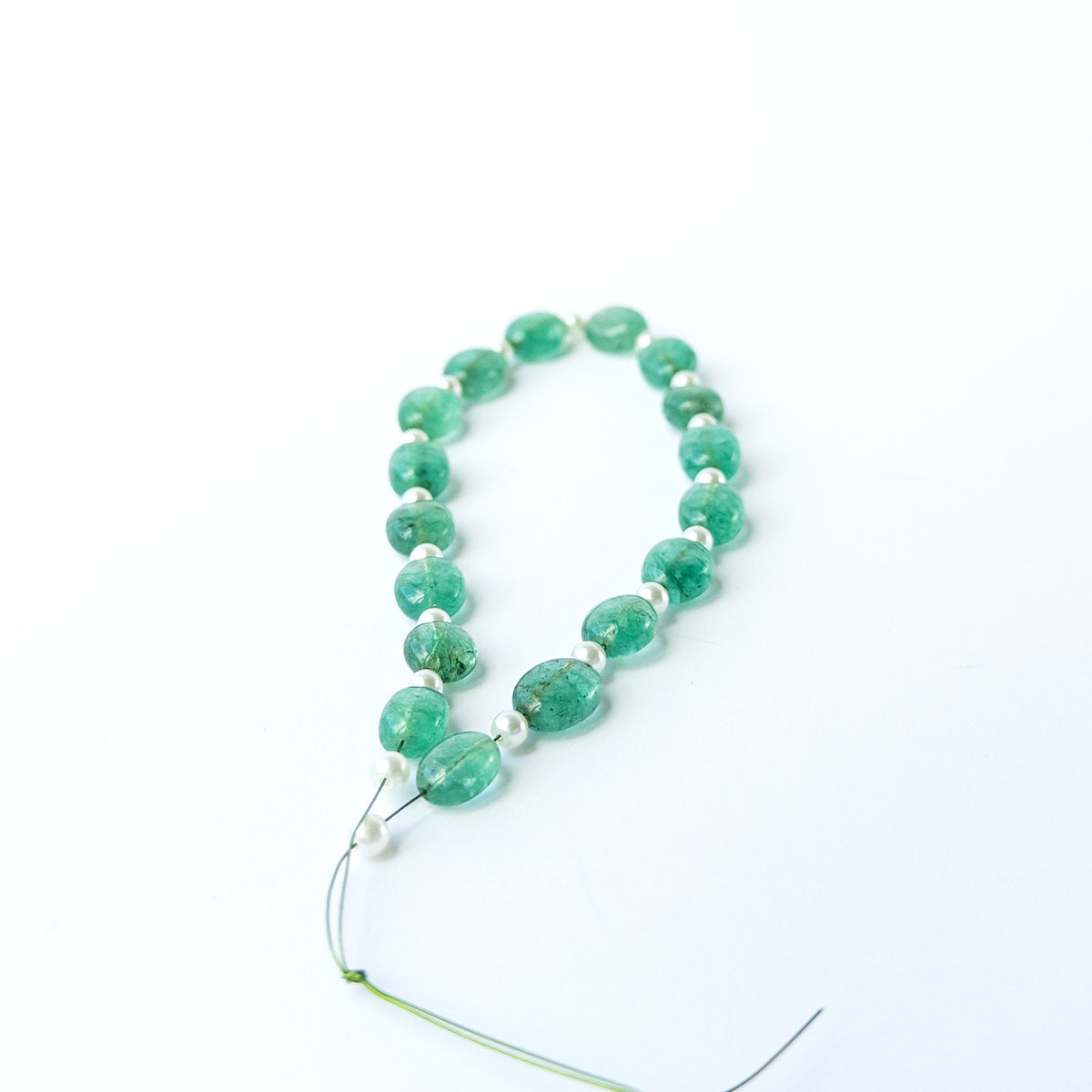 Smooth oval Green Beryl and Shell Pearl beads with refined shaping and natural lustre.
