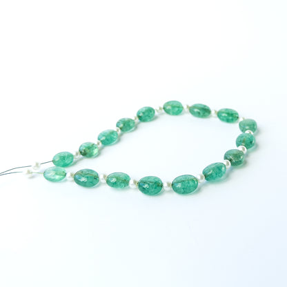 Close‑up of Green Beryl and Shell Pearl smooth oval beads showing their polished surface and clarity.