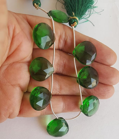 A hand displays a strand crafted from Green Hydo beads, adorned with an array of colourful gemstones.