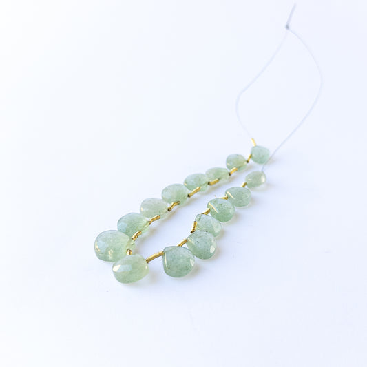 Green Strawberry Quartz faceted briolette gemstone beads with fresh green sparkle arranged in a 10.2–12.7mm set.
